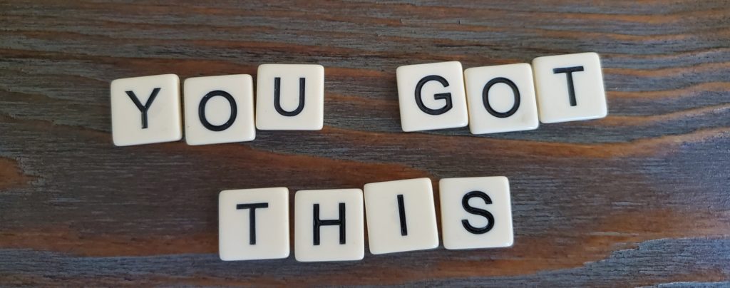 White letter tiles on a wooden surface read, "You Got This."