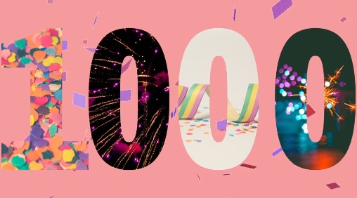 Block letters of the number 1000 with confetti and fireworks filling each number. Set on a pink background.